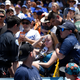 A young fan is carted away after being hit with a foul ball hit by Los Angeles Dodgers’ Cody Bellinger during the first inning of a baseball game against the Colorado Rockies, Sunday, June 23, 2019, in Los Angeles.